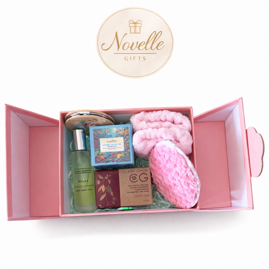 Pink gift box with bath products and a card